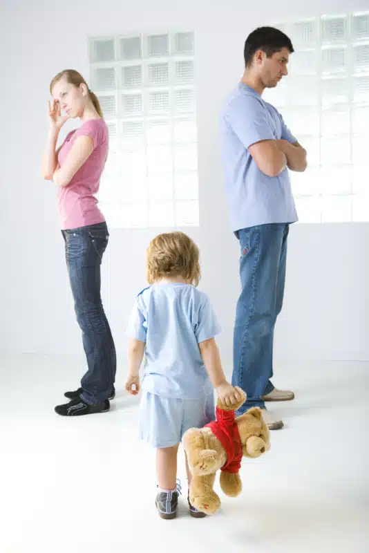 An image of two happy parents working together to care for their child, representing the theme of successful co-parenting after separation or divorce.